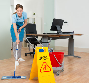 Office-cleaner-sweeping-the-floor